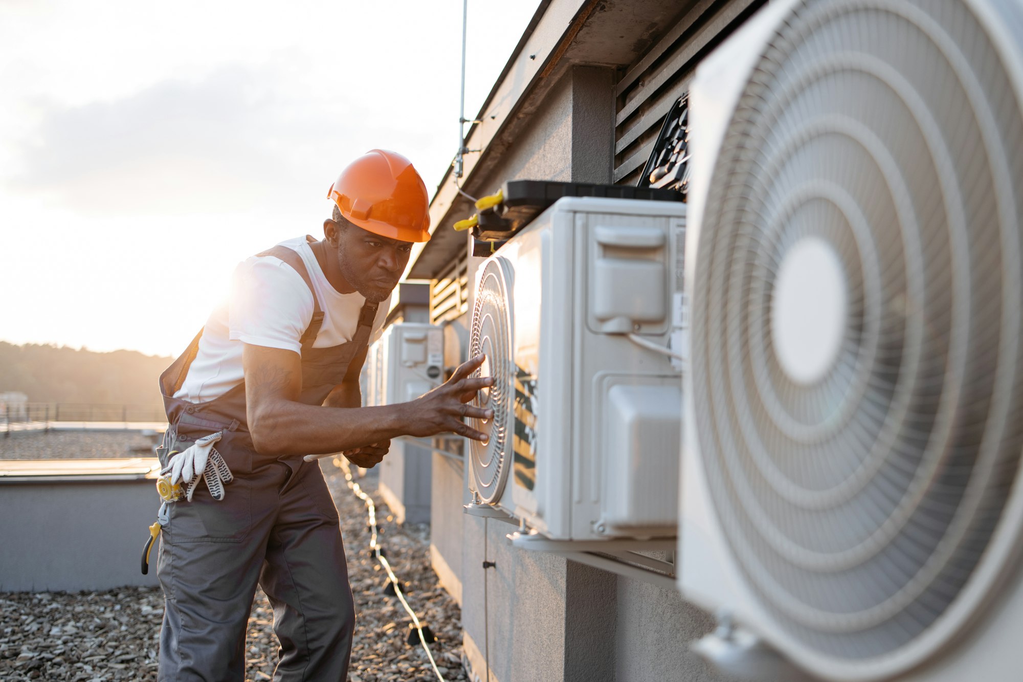 Male holding tablet and installing cooling system outdoors