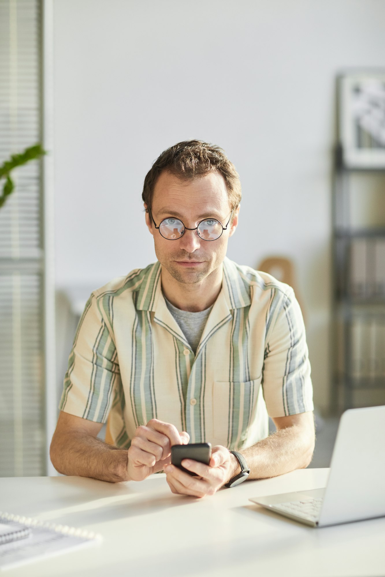 Man Using Smartphone In Office